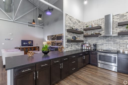 a kitchen with a large island and stainless steel appliances at Aviator at Brooks, San Antonio