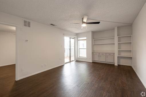 Empty room with wooden floor and white walls.