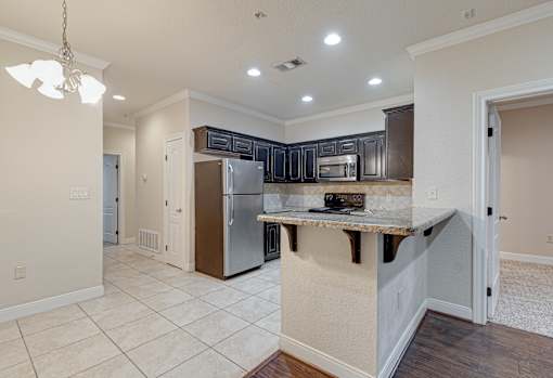 A kitchen with a refrigerator, microwave, and oven at Logan Ridge Apartments, San Marcos, TX, 78666