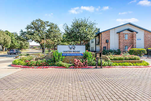 A sign in front of a building that says Water Ridge at Water Ridge Apartments , Irving, Texas