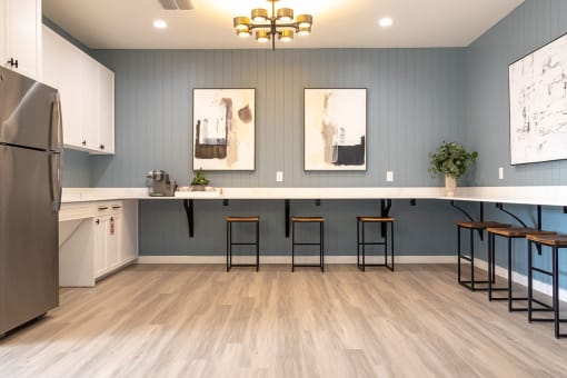 a kitchen with a long counter and stools  at Sunset Canyon, San Antonio, TX
