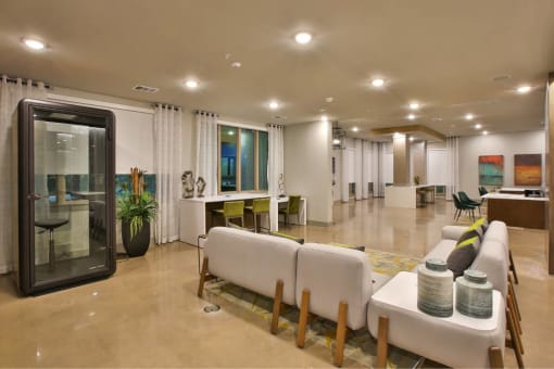 a large living room with white couches and chairs at The Grand at Stonecreek, San Marcos