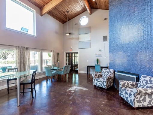 a living room and dining room with a glass table and chairs at Water Ridge Apartments, Irving, TX