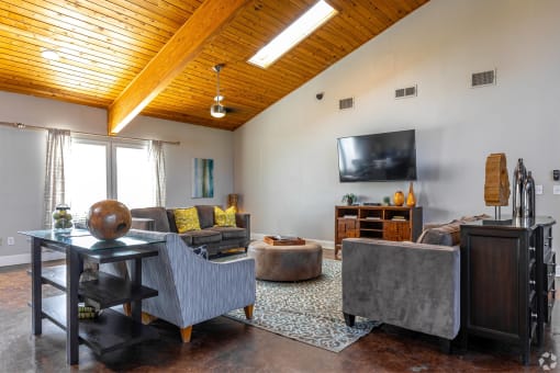 a living room with couches and a tv at Water Ridge Apartments, Texas, 75061