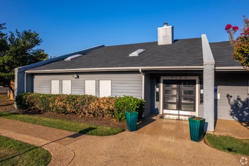 the front of a house with a driveway and a glass door at Water Ridge Apartments, Irving, Texas
