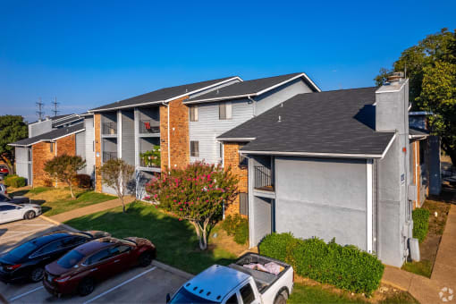 an apartment building with cars parked in front of it at Water Ridge Apartments, Texas