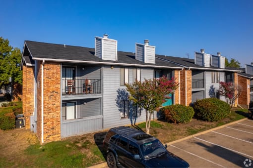 an apartment building with a car parked in front of it at Water Ridge Apartments, Irving, TX 75061