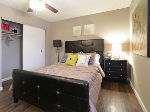a bedroom with a large bed and a closet at Water Ridge Apartments, Texas