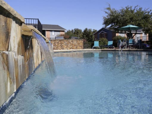 a large swimming pool with water coming out of it at Water Ridge Apartments, Texas