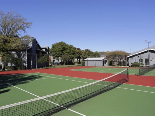 a tennis court with green and red lines on it at Water Ridge Apartments, Irving, TX