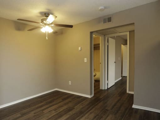 an empty living room with a ceiling fan at Water Ridge Apartments, Irving