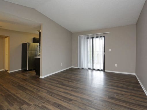 an empty living room with a refrigerator and at Water Ridge Apartments, Irving, TX 75061