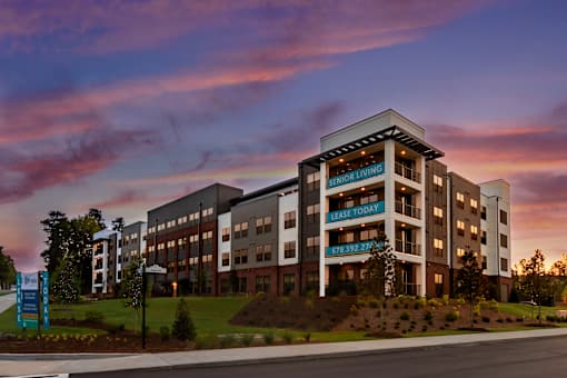a rendering of an apartment building at sunset