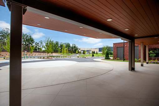 a view of the pool area from under a wood canopy