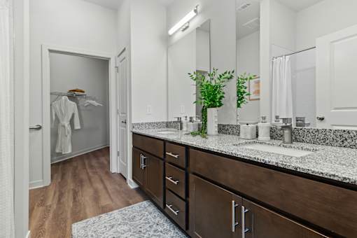 A bathroom with a wooden floor and white walls.