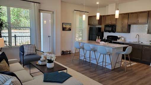 A modern kitchen with a dining table and chairs.