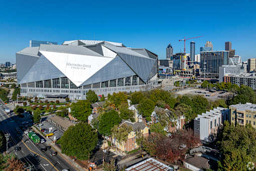 A large, modern building with a grey facade dominates the skyline.