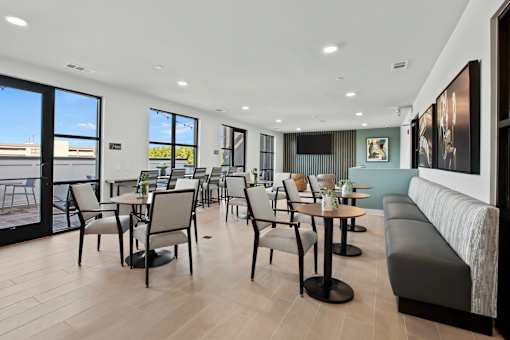 a dining room with tables and chairs and a balcony