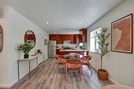 A modern kitchen with wooden floors and furniture.