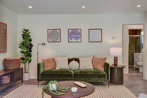 A living room with a green couch and a coffee table.