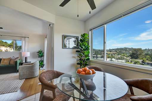A modern dining room with a glass table and chairs.