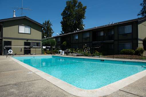 A swimming pool in front of a building.