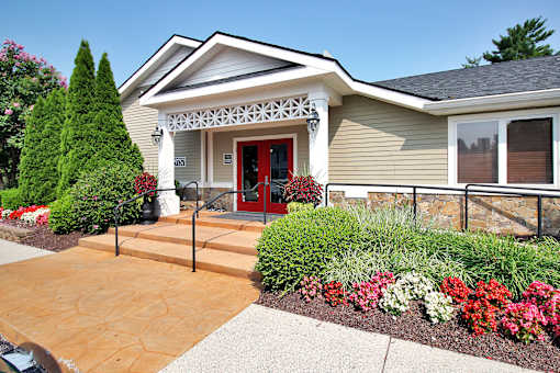 A house with a red door and a stone wall.