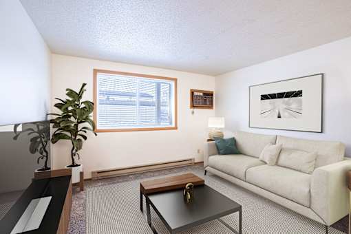 A living room with a couch, coffee table, and a plant. Fargo, ND Candlelight Apartments