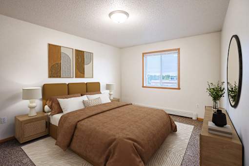 A bedroom with a brown bedspread and a brown headboard. Fargo, ND Summit Point Apartments