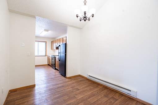 A black refrigerator in a kitchen with white walls. Fargo, ND Somerset Apartments