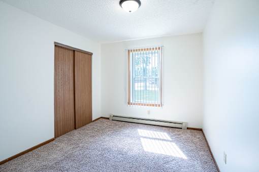 A room with a window and a door.