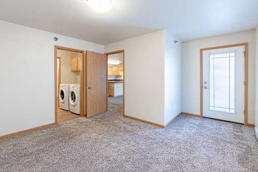 A laundry room with a washer and dryer in it. Moorhead, MN Sandy Creek Apartments