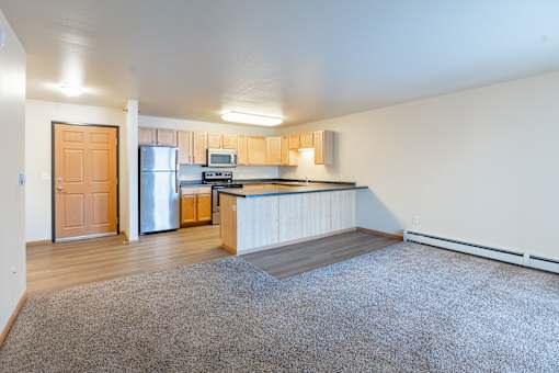 A kitchen with a refrigerator, microwave, and oven. Moorhead, MN Sandy Creek Apartments