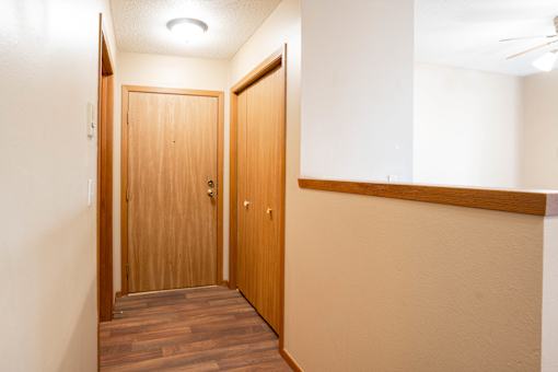 A hallway with two doors and a light on the ceiling.