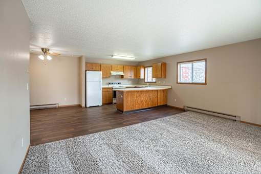 A kitchen with wooden cabinets and a white refrigerator.