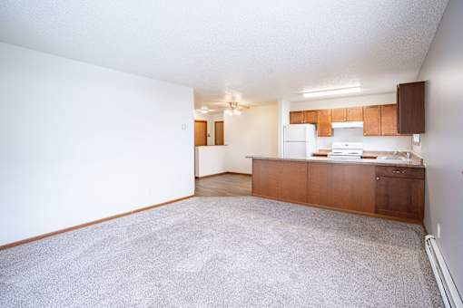 A kitchen area with a counter and cabinets. Fargo, ND Westwood Estates
