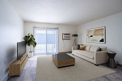 A living room with a couch, a coffee table, and a television. Moorhead, MN Woodstone Apartments