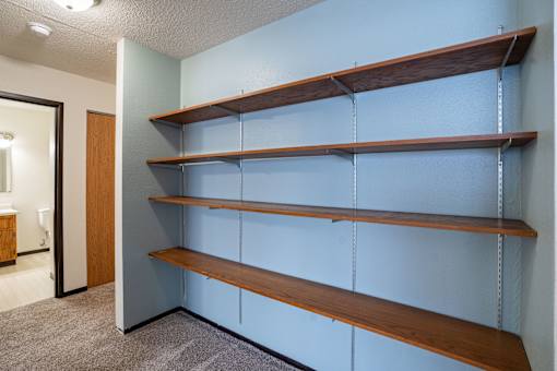 A wall of shelves in a room.