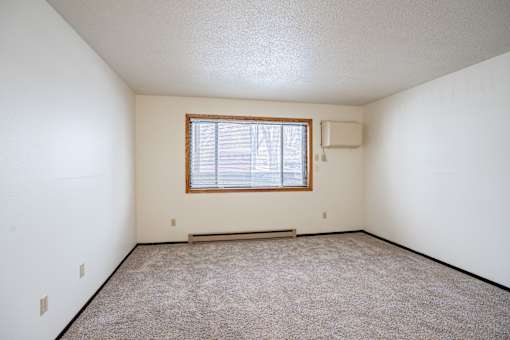 A room with a window and a bench.