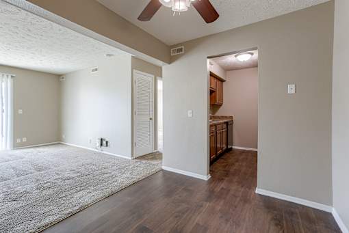 A room with a ceiling fan and wooden floors. Omaha, NE Evergreen Terrace Apartments