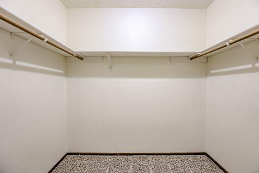 A small, empty room with a carpeted floor and two shelves. Omaha, NE Stony Brook Apartments