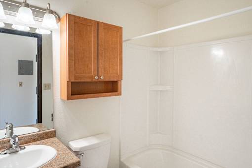 A white bathroom with a sink, toilet and bathtub. Fargo, ND Pacific Park I Apartments