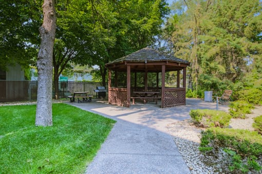 Anoka, MN Dellwood Estates Apartments. a gazebo in a park with trees