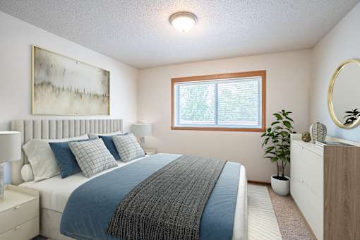 A bedroom with a bed, nightstand, and a painting on the wall. Fargo, ND West Oak Apartments