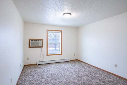 A room with a window and a picture on the wall. Fargo, ND Park Place Apartments