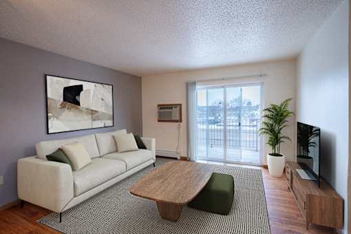 A living room with a white couch and a wooden coffee table. Fargo, ND Park Place Apartments