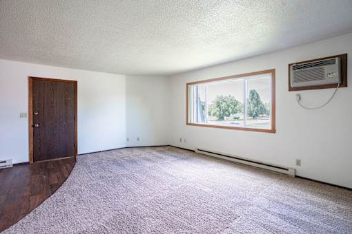 A room with a window and a door. Fargo, ND Summerfield Apartments