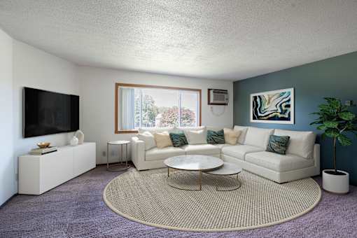 A living room with a white couch, a television, and a coffee table. Fargo, ND Summerfield Apartments