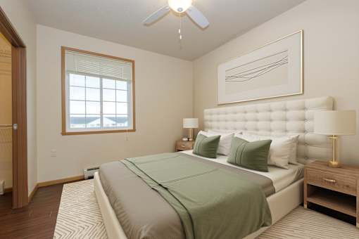 A bedroom with a large bed and a ceiling fan.