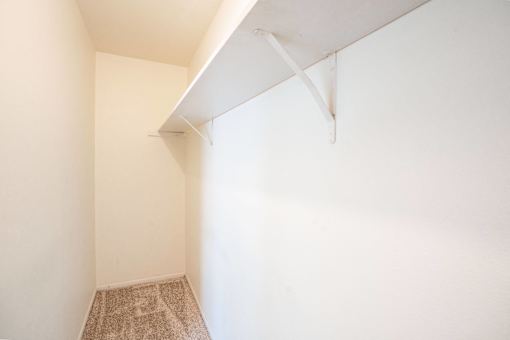A room with a carpeted floor and a white ceiling. West Fargo, ND Sheyenne Terrace Townhomes